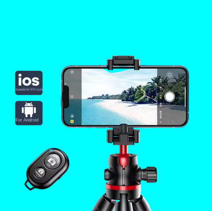 Phone with camera app open on a tripod, Bluetooth remote control, and scenic background